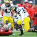 Michigan defensive end Frank Clark stands over receiver Ohio State quarterback Braxton Miller after sacking the quarterback in the first half at Ohio Stadium on Saturday. Melanie Maxwell I AnnArbor.com